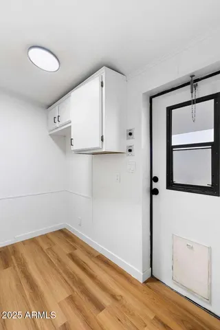 a view of a room with wooden floor and cabinet