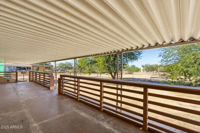 a view of a street with wooden fence