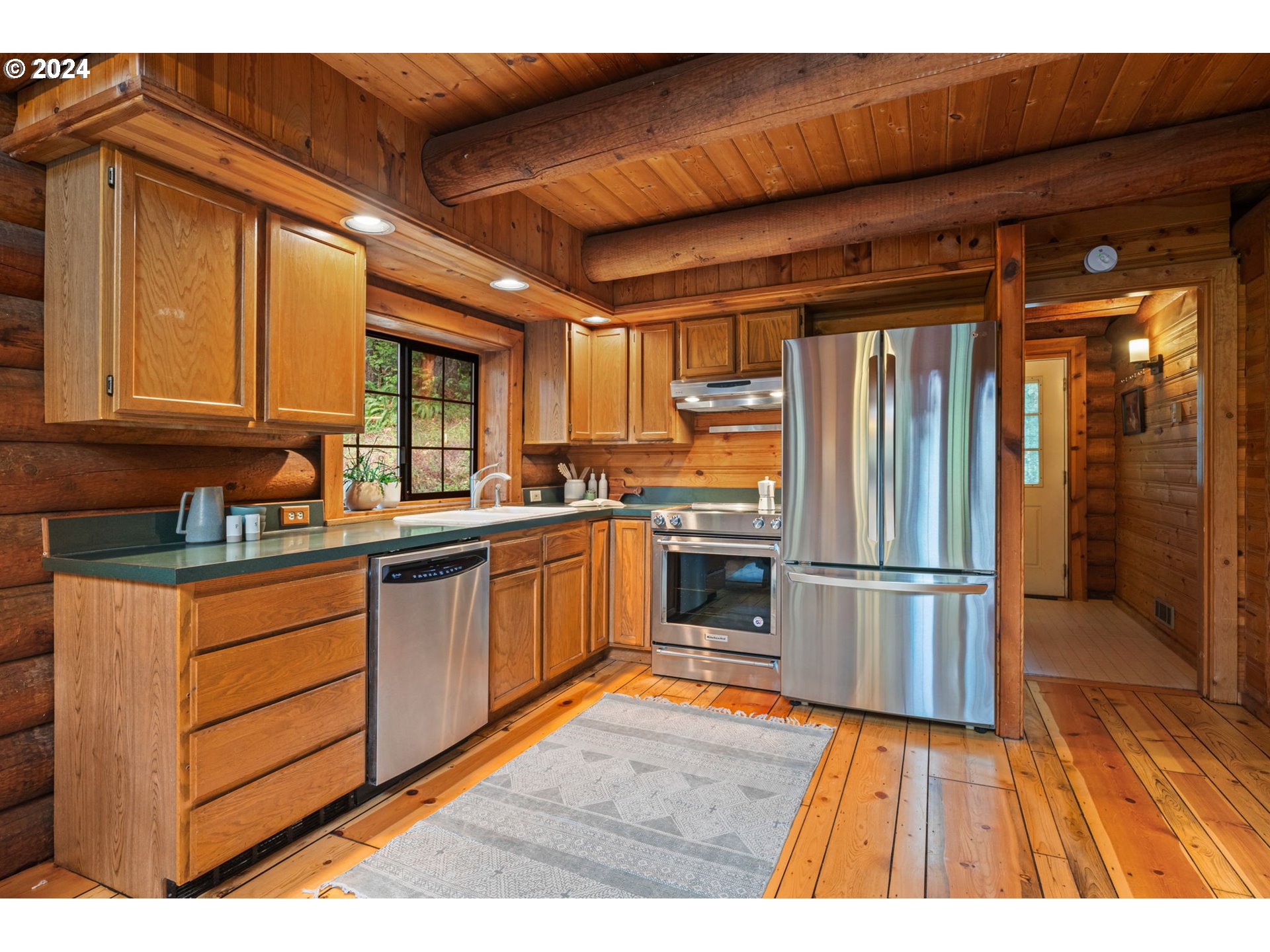 24271 South Newkirchner Road Oregon City, OR 97045 - Photo 13 of 41 a kitchen with granite countertop wooden floors stainless steel appliances and a counter