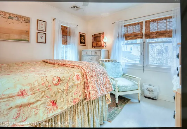 a bed sitting in a bedroom next to a window