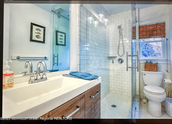 a bathroom with a sink toilet and shower