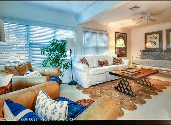 a living room with furniture and a potted plant