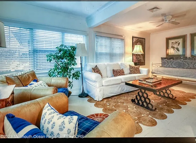 a living room with furniture and a potted plant