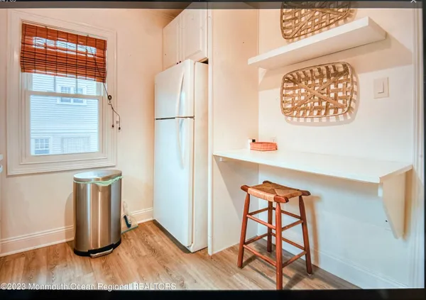 a view of hallway with windows and wooden floor