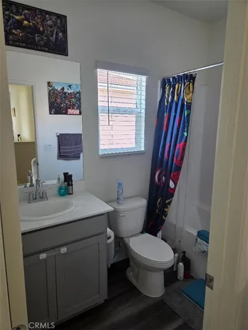 a bathroom with a toilet a sink and a mirror