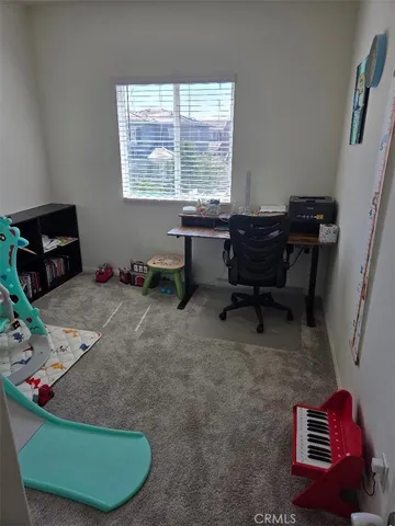 a room with furniture gym equipment and a window