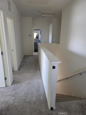 a view of hallway with furniture and wooden floor