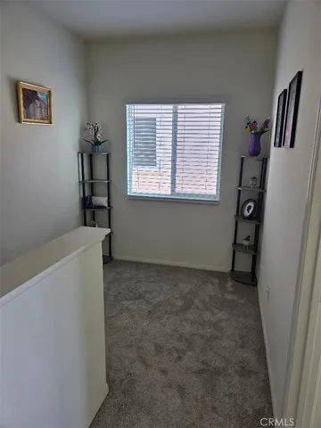 a view of livingroom with window and refrigerator
