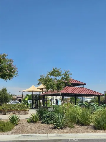 a view of a house with a yard and sitting area