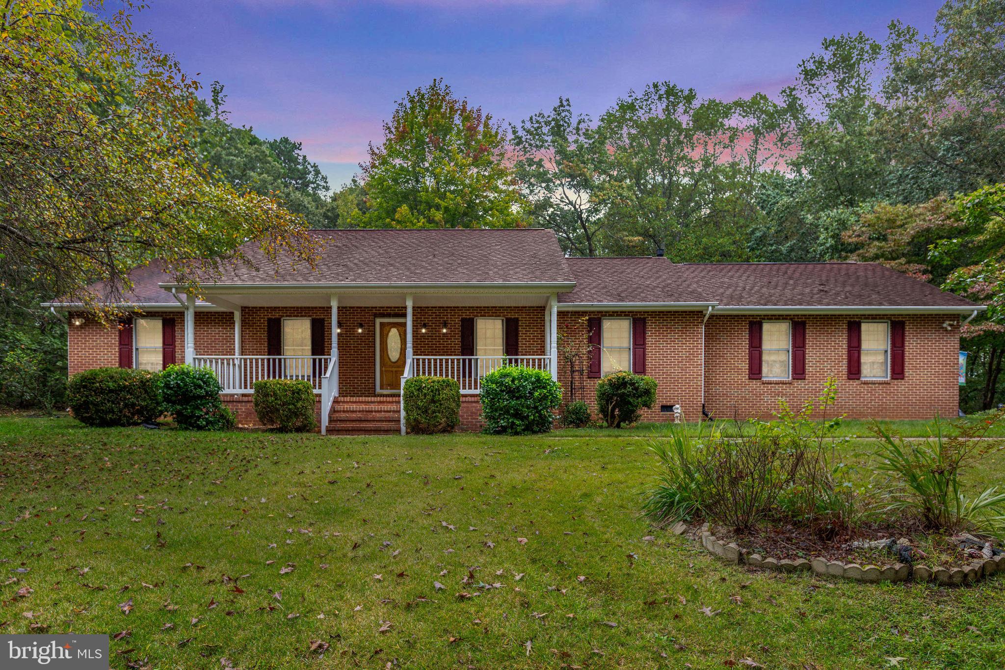 6628 Courthouse Road Spotsylvania, VA 22551 - Photo 1 of 45 a front view of a house with a yard and garage
