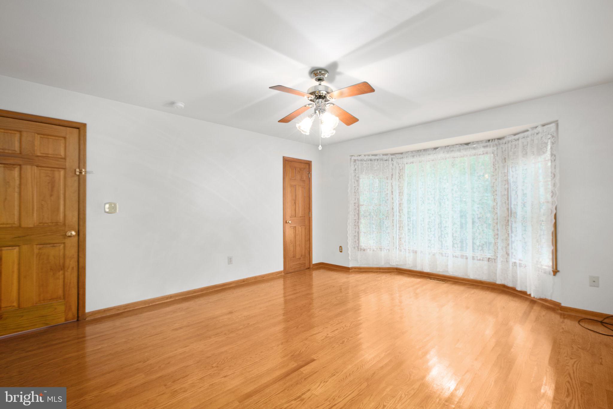 6628 Courthouse Road Spotsylvania, VA 22551 - Photo 18 of 45 a view of an empty room with window and wooden floor