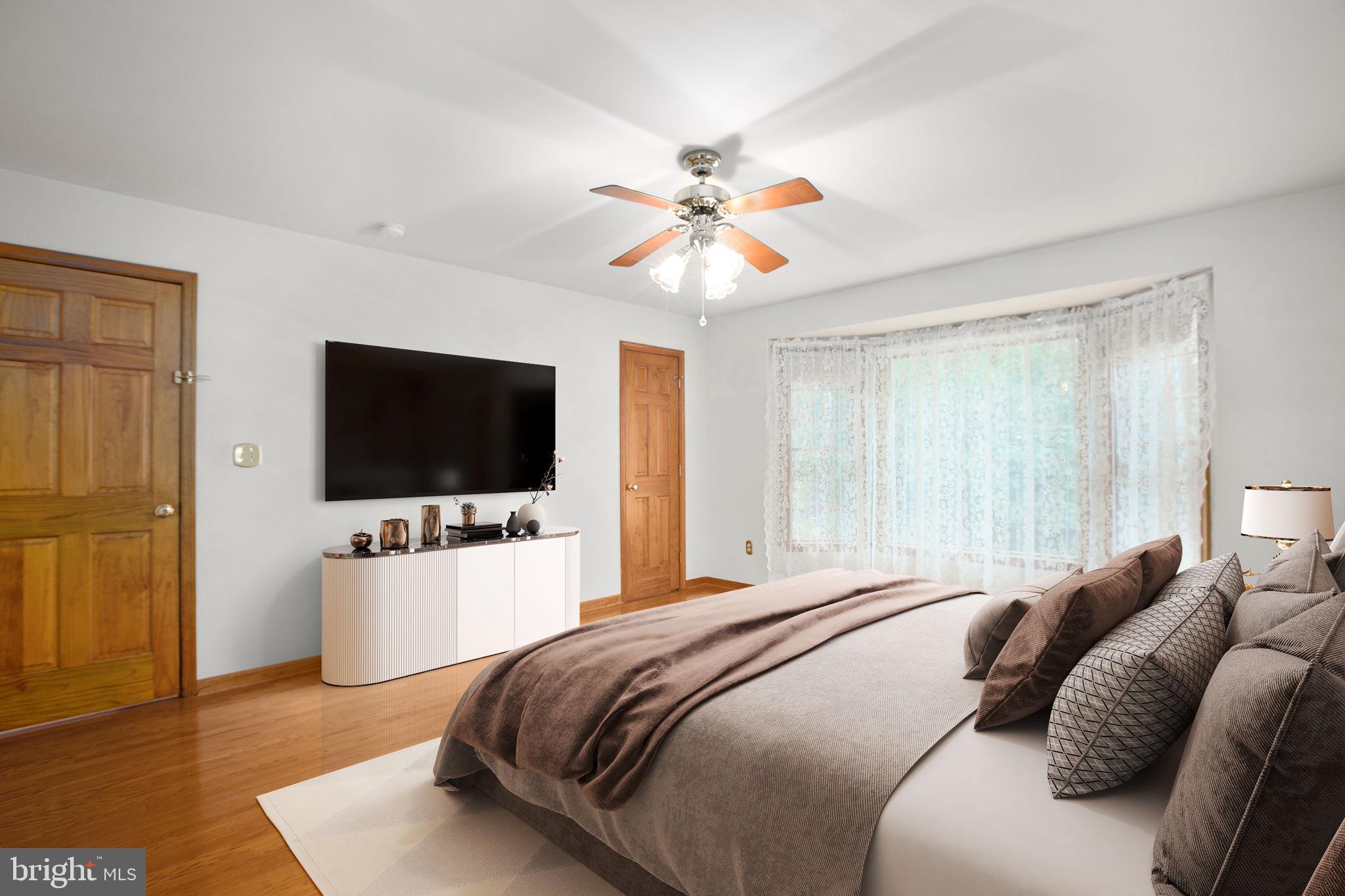 6628 Courthouse Road Spotsylvania, VA 22551 - Photo 20 of 45 a bedroom with a bed and a flat screen tv