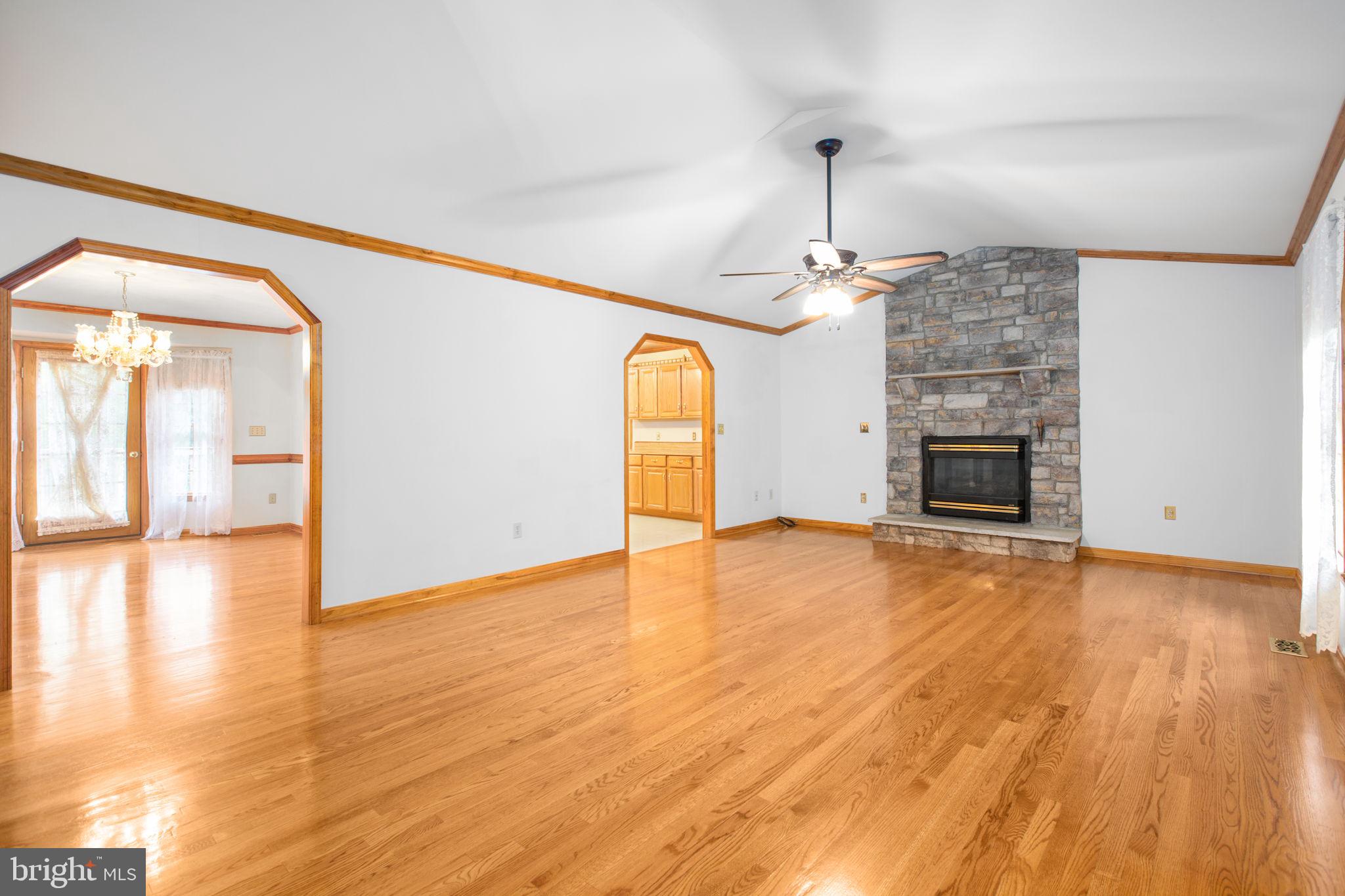 6628 Courthouse Road Spotsylvania, VA 22551 - Photo 2 of 45 a view of empty room with wooden floor fireplace and a window
