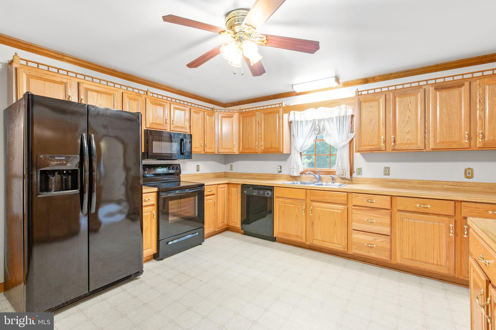 6628 Courthouse Road Spotsylvania, VA 22551 - Photo 3 of 45 a kitchen with granite countertop stainless steel appliances a sink cabinets and a window