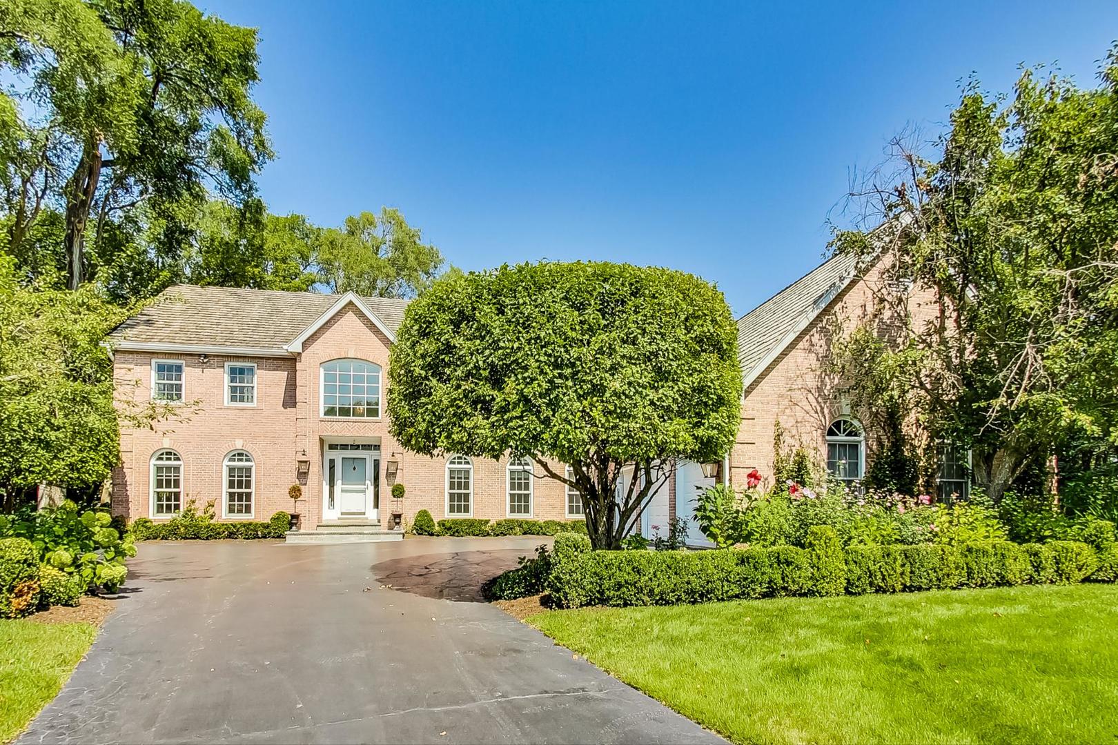 1387 Gettysburg Road Long Grove, IL 60047 - Photo 1 of 46 a view of a white house with a big yard plants and large trees