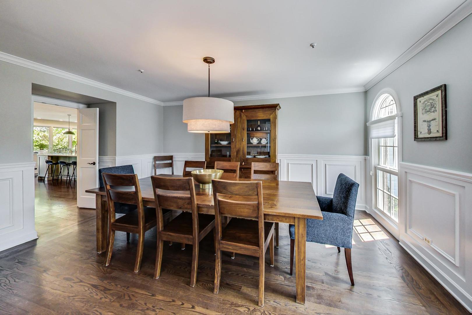 1387 Gettysburg Road Long Grove, IL 60047 - Photo 13 of 46 a view of a dining room and livingroom with furniture wooden floor a rug a painting and a chandelier