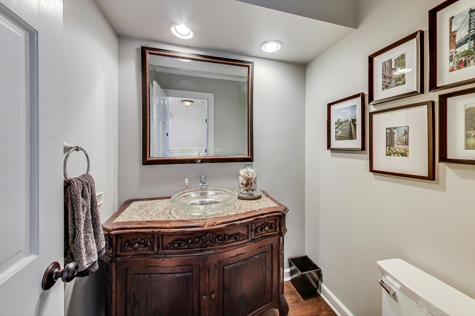 1387 Gettysburg Road Long Grove, IL 60047 - Photo 16 of 46 a bathroom with a sink a toilet and mirror