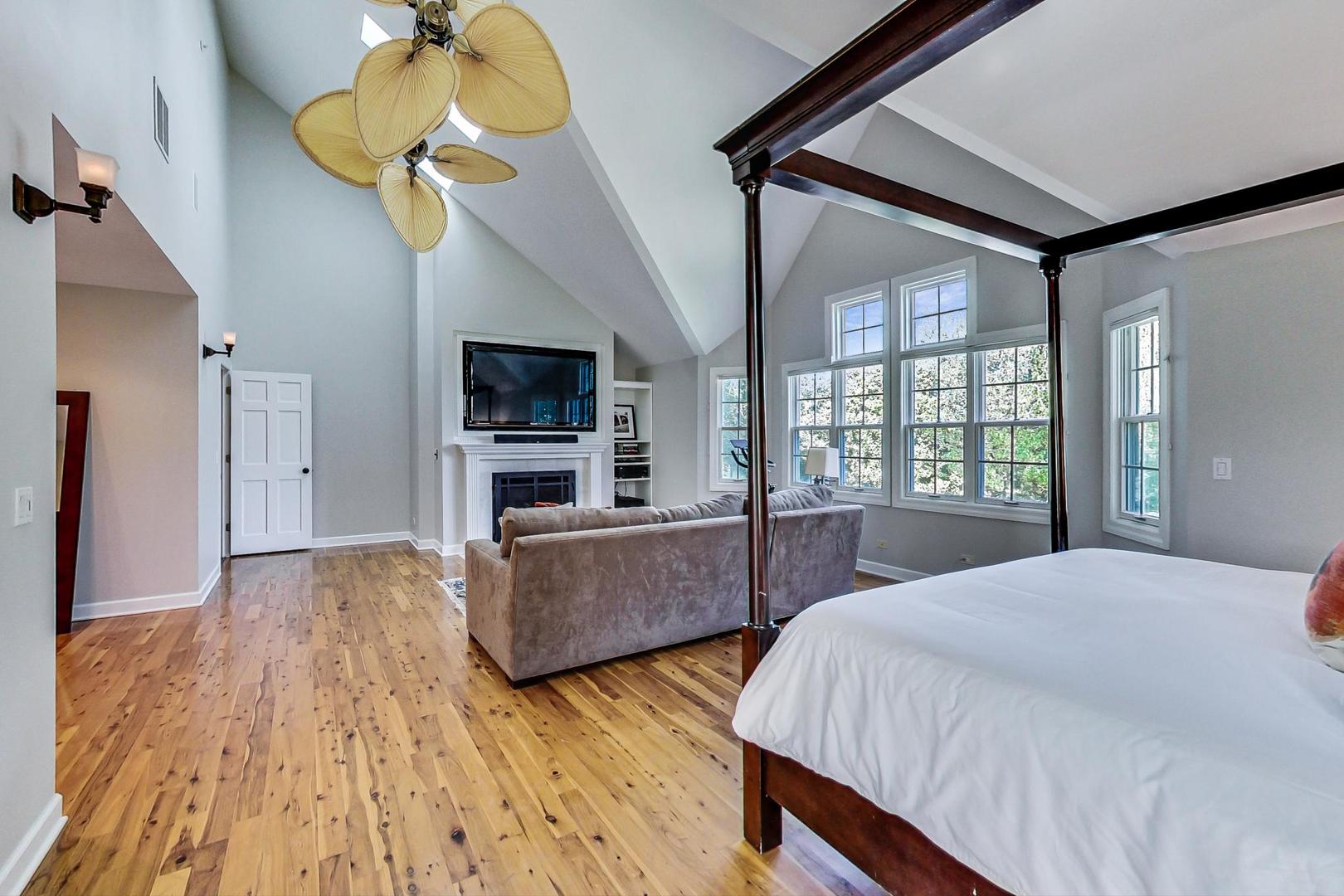 1387 Gettysburg Road Long Grove, IL 60047 - Photo 20 of 46 a bedroom with a bed and a chandelier