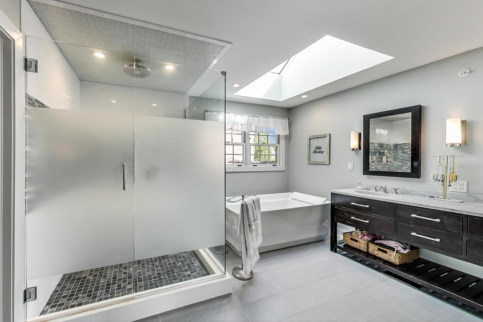 1387 Gettysburg Road Long Grove, IL 60047 - Photo 24 of 46 a spacious bathroom with a double vanity sink a mirror and a bathtub