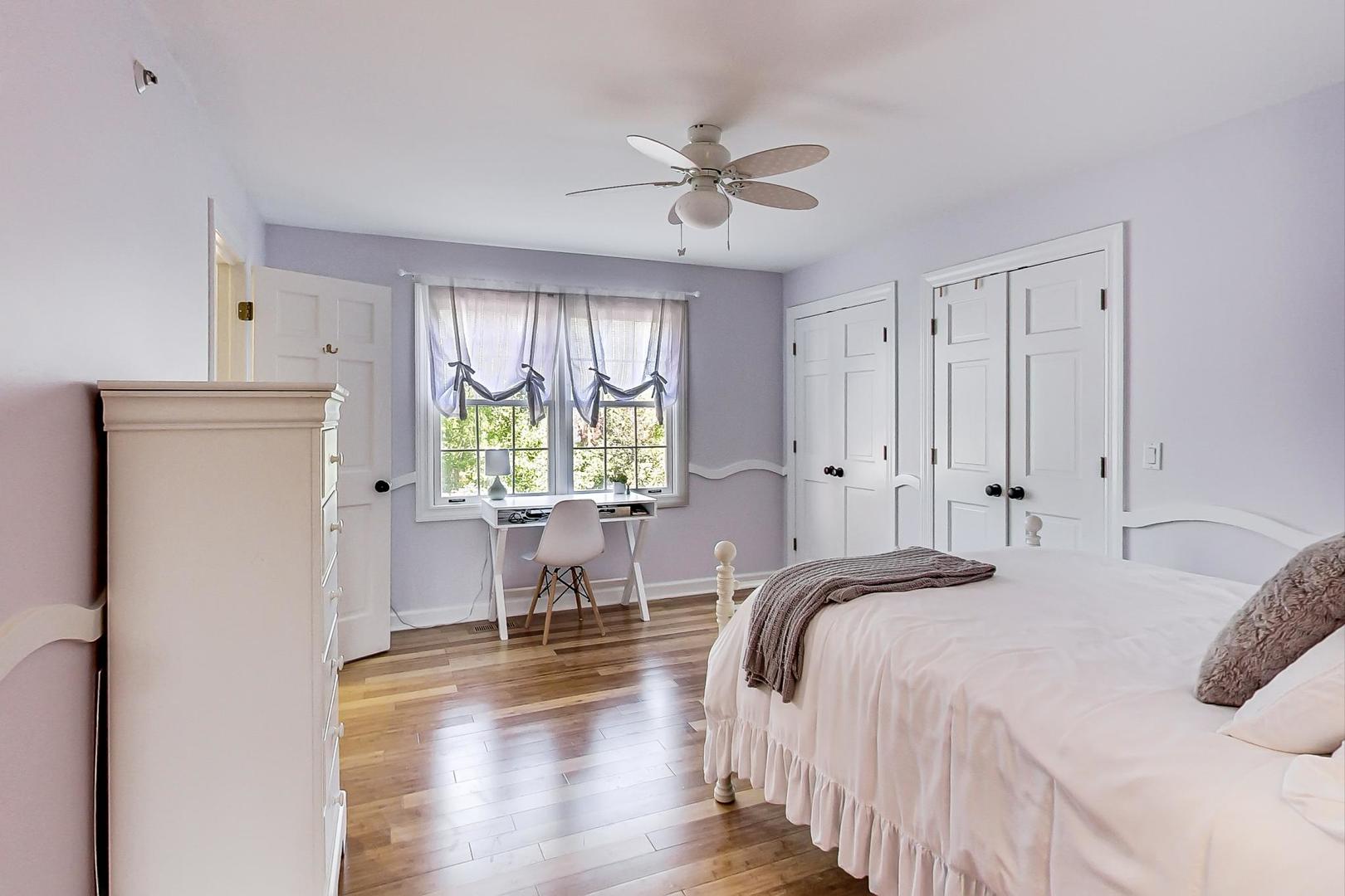 1387 Gettysburg Road Long Grove, IL 60047 - Photo 26 of 46 a bedroom with a bed and a chandelier
