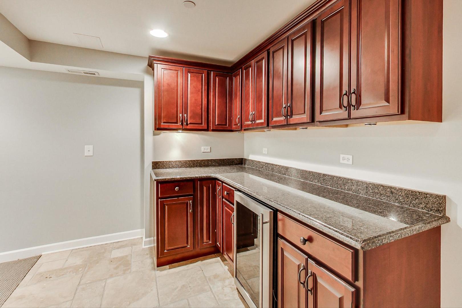 1387 Gettysburg Road Long Grove, IL 60047 - Photo 34 of 46 a kitchen with granite countertop cabinets and window