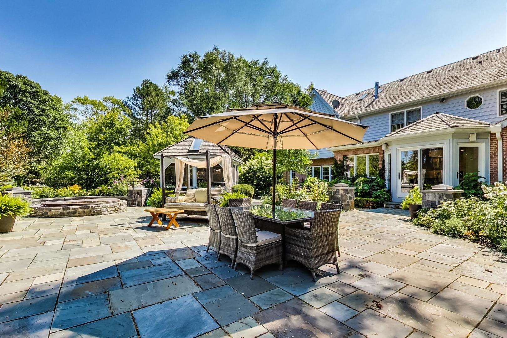 1387 Gettysburg Road Long Grove, IL 60047 - Photo 37 of 46 a view of a patio with a table and chairs under an umbrella