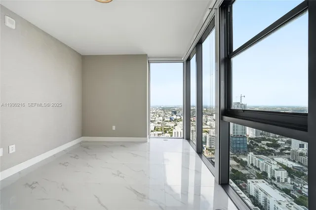 an empty room with windows and closet