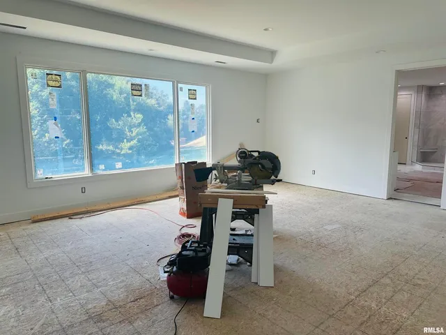 a room with furniture and large windows