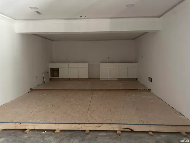 a spacious bedroom with a bed and a large mirror