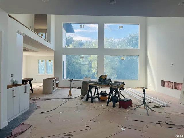 a living room with furniture and large windows