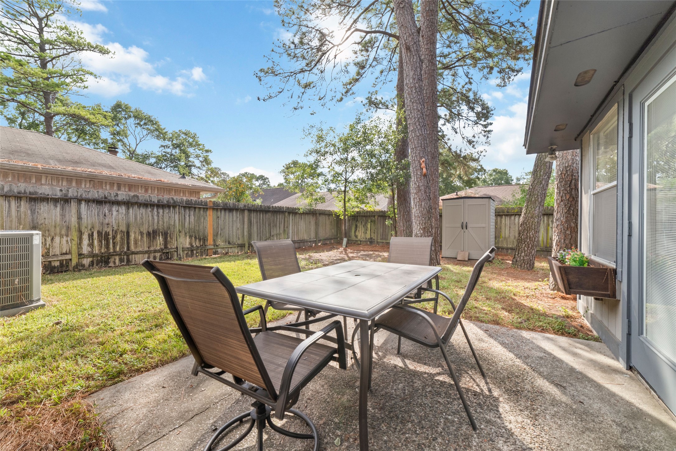 4711 Lost Lake Lane Spring, TX 77388 - Photo 24 of 26 a view of a patio with a table chairs and a backyard