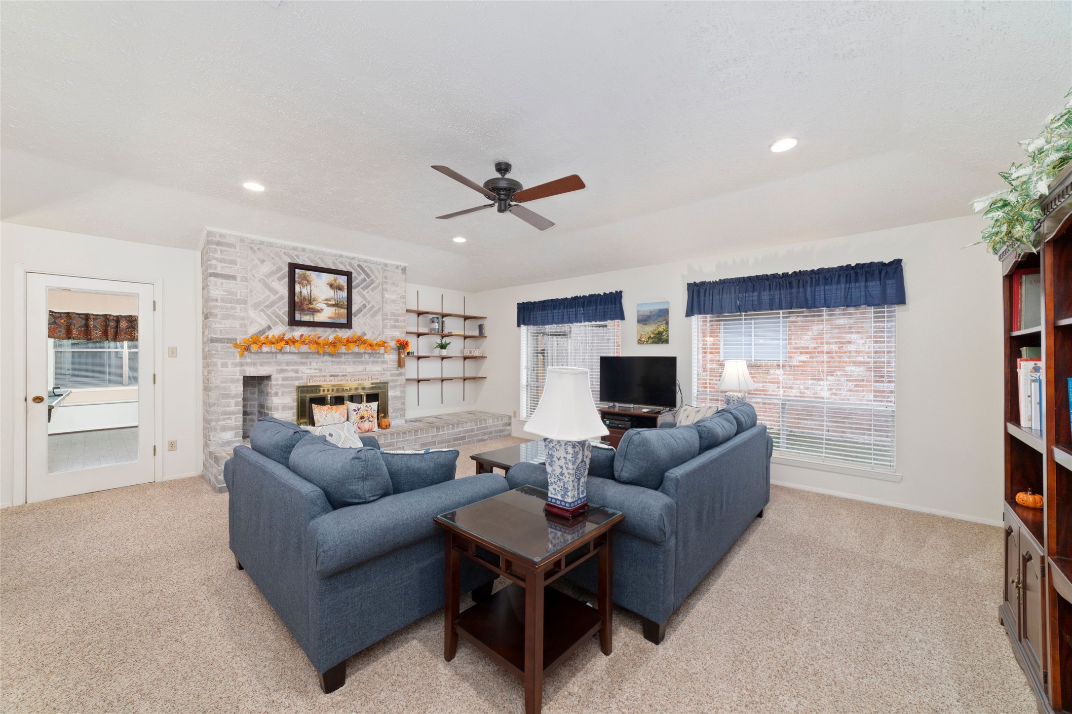 4711 Lost Lake Lane Spring, TX 77388 - Photo 3 of 26 a living room with furniture a flat screen tv and a fireplace