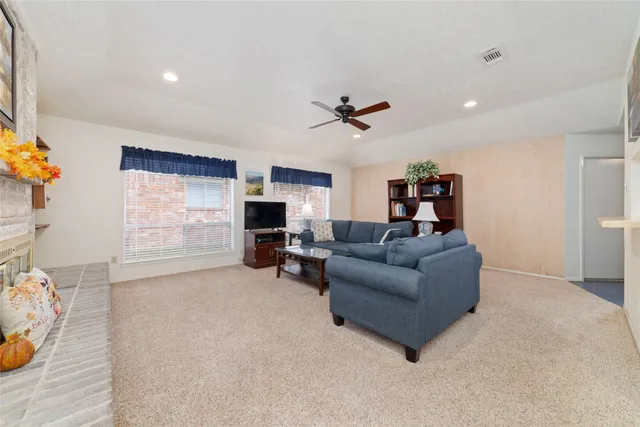 a living room with furniture a fireplace and a flat screen tv