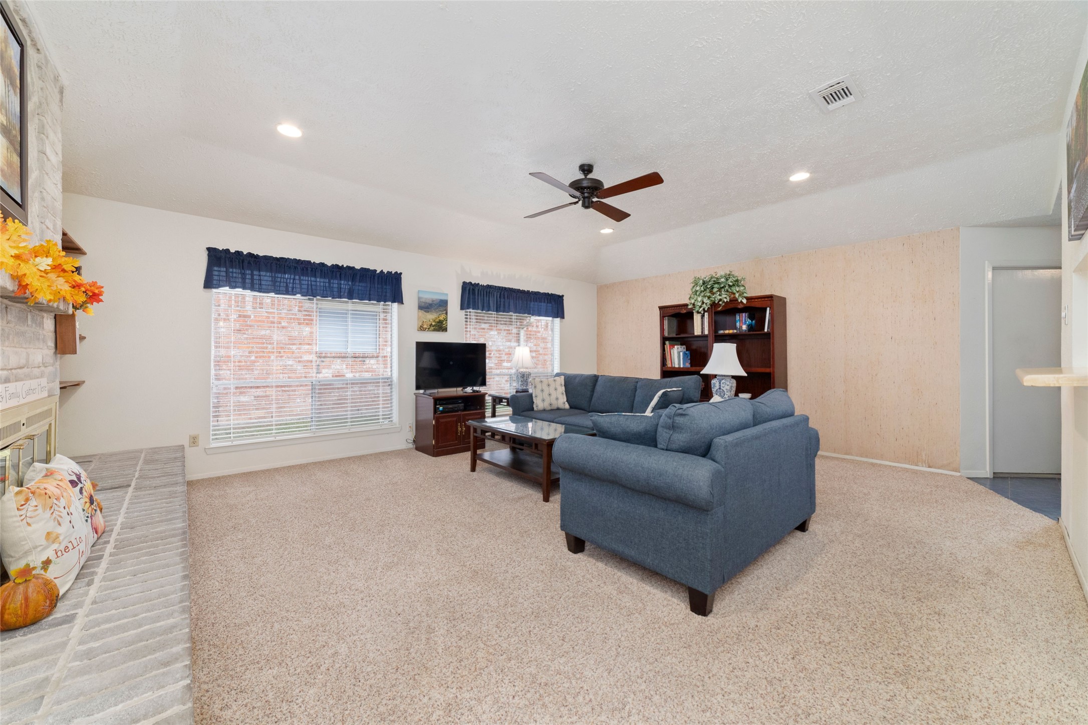 4711 Lost Lake Lane Spring, TX 77388 - Photo 8 of 26 a living room with furniture a fireplace and a flat screen tv