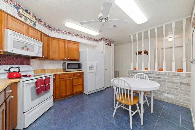 a kitchen that has a table and chairs in it