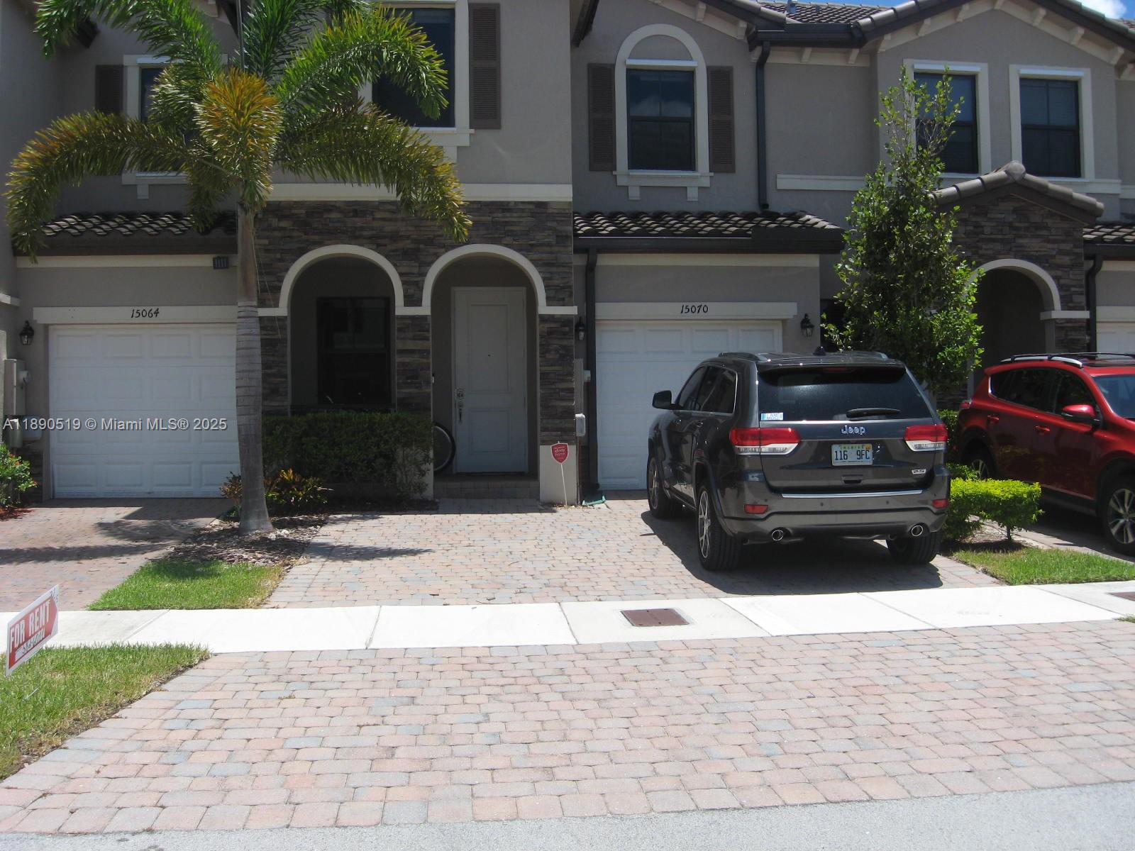15070 Southwest 117th Way Miami, FL 33196 - Photo 2 of 14 a view of a car parked in front of a house