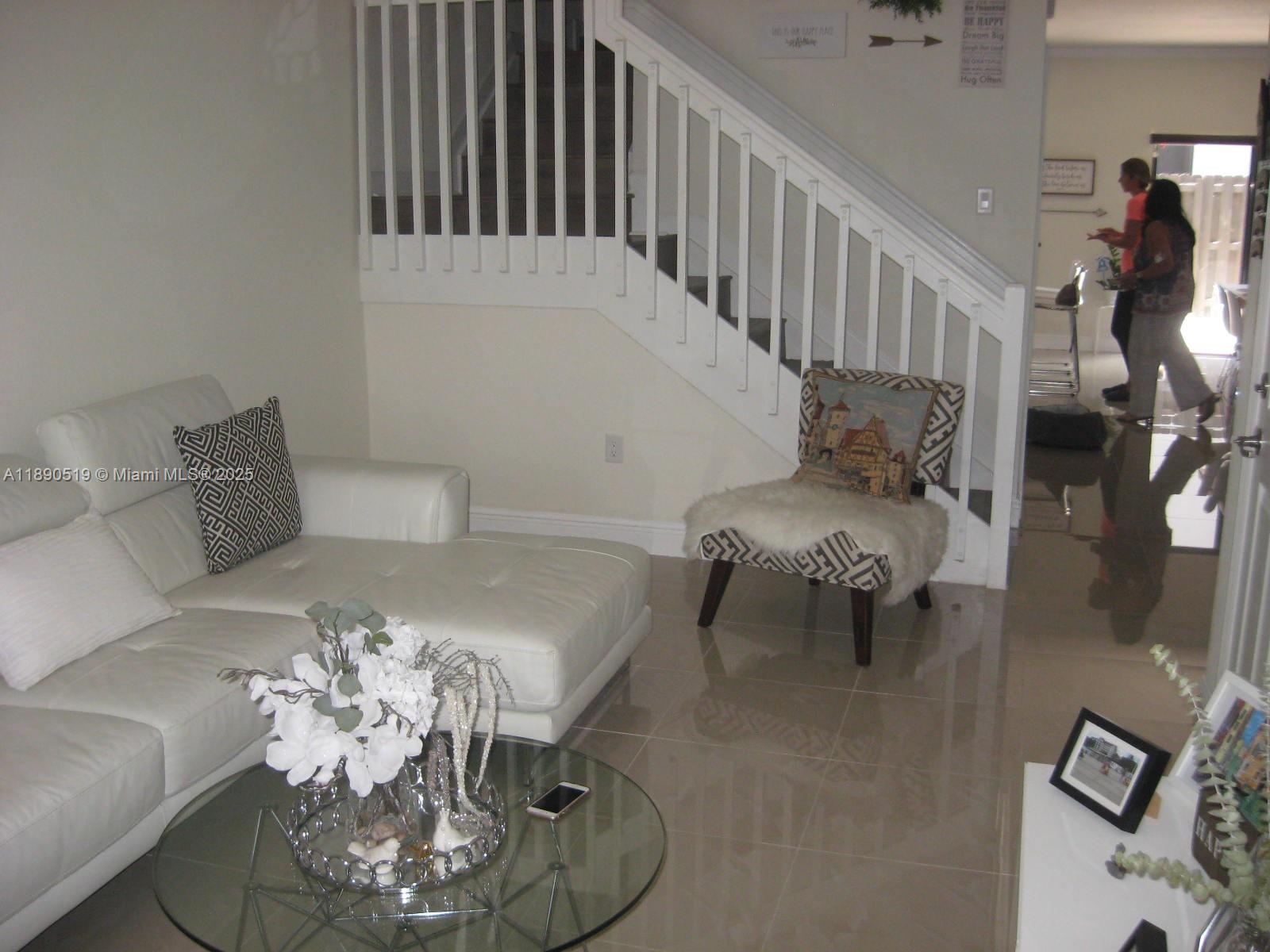 15070 Southwest 117th Way Miami, FL 33196 - Photo 3 of 14 a living room with furniture chandelier and a table