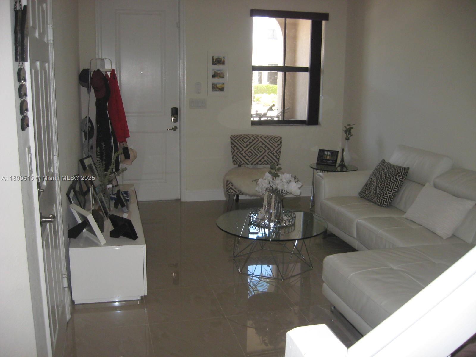 15070 Southwest 117th Way Miami, FL 33196 - Photo 4 of 14 a living room with furniture and a flat screen tv