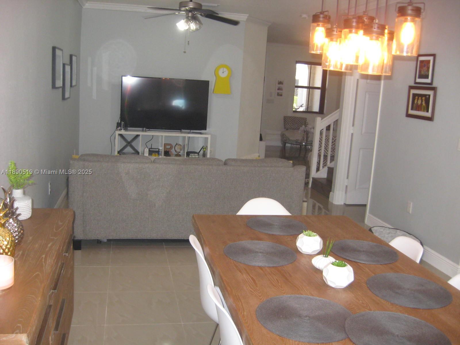 15070 Southwest 117th Way Miami, FL 33196 - Photo 9 of 14 a living room with furniture and a flat screen tv