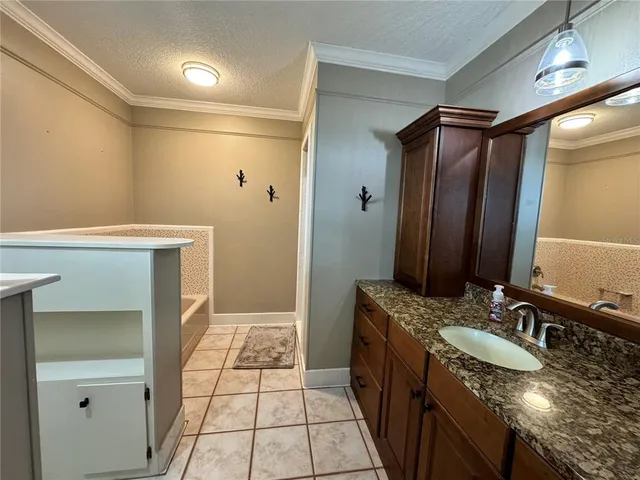 a bathroom with a granite countertop sink a toilet and mirror