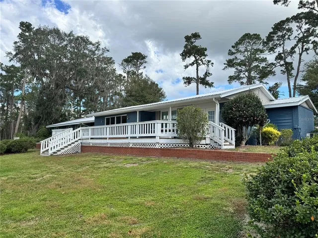 a front view of a house with a yard table and chairs