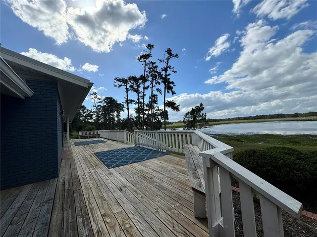 a view of balcony with wooden floor and fence