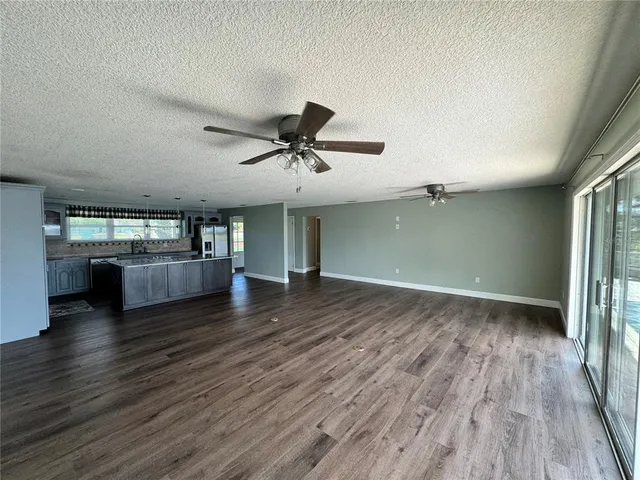a view of a livingroom with hardwood floor and a ceiling fan
