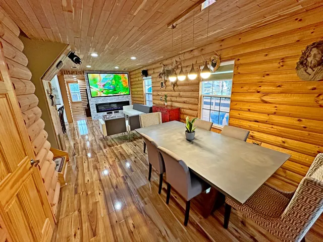 a view of a patio with table and chairs with wooden floor and fence