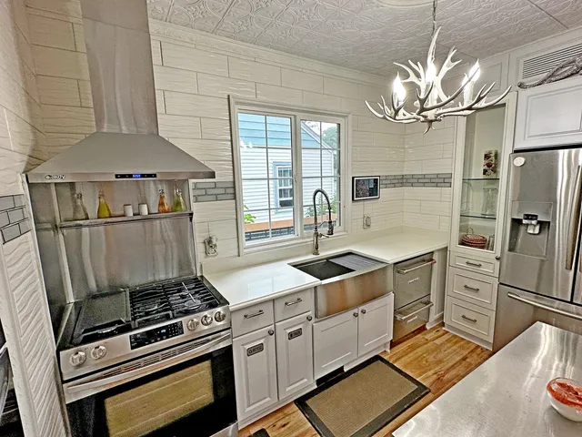 a kitchen with stainless steel appliances a stove a refrigerator and cabinets