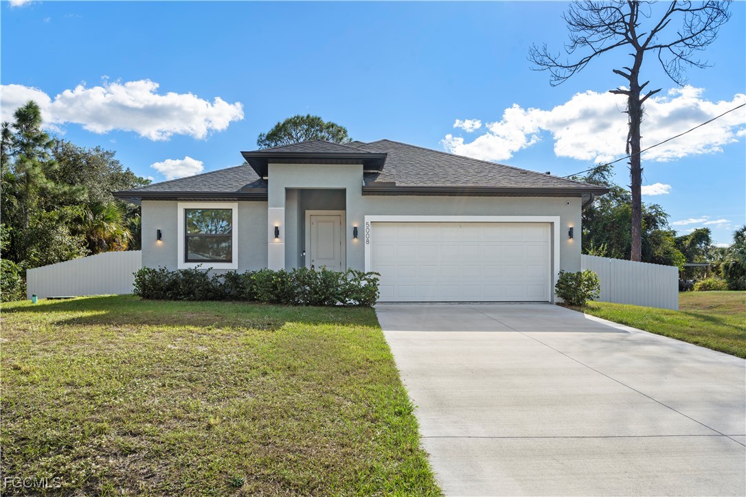 5008 Myrtlewood Road LaBelle, FL 33935 - Photo 1 of 37 a front view of a house with garden