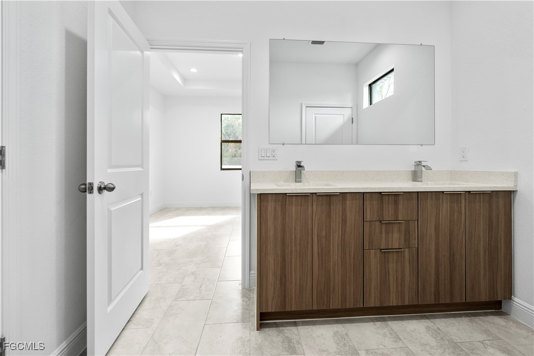 5008 Myrtlewood Road LaBelle, FL 33935 - Photo 14 of 37 a bathroom with a sink and a mirror