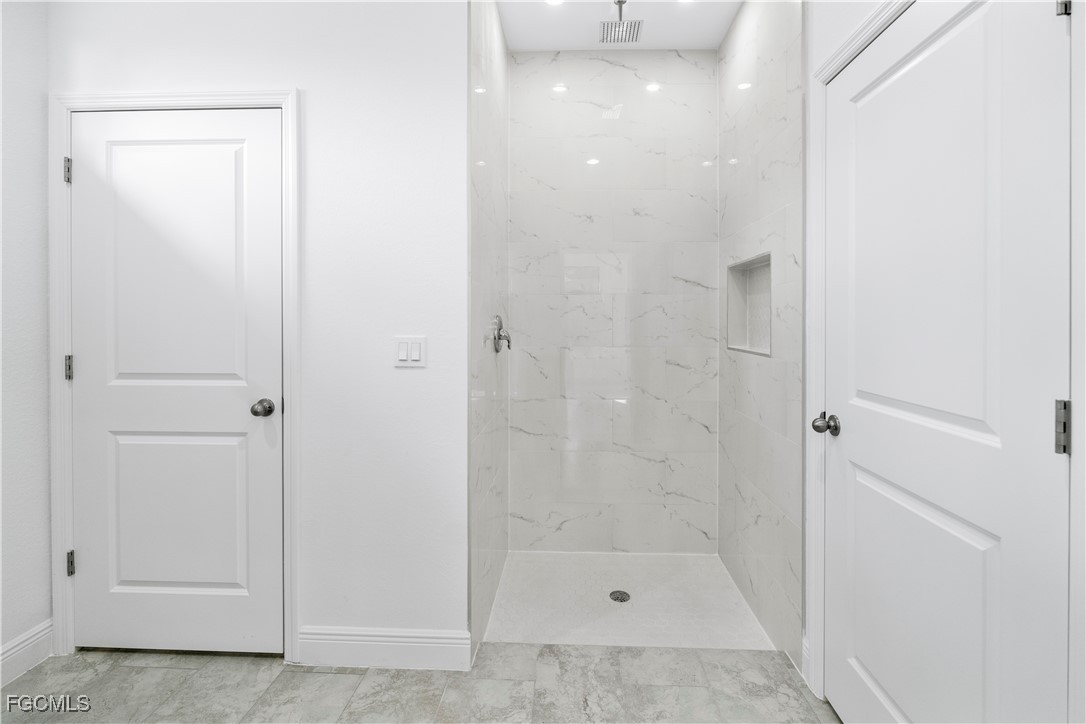 5008 Myrtlewood Road LaBelle, FL 33935 - Photo 15 of 37 a bathroom with a glass shower door