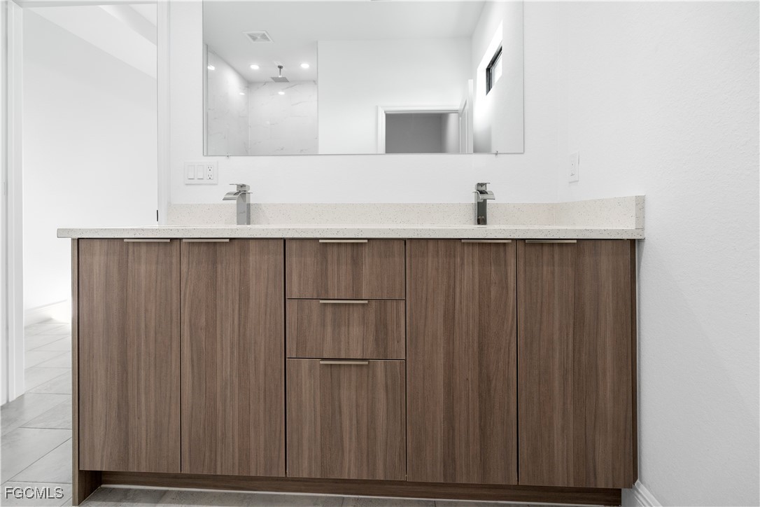 5008 Myrtlewood Road LaBelle, FL 33935 - Photo 16 of 37 a bathroom with a sink and a mirror