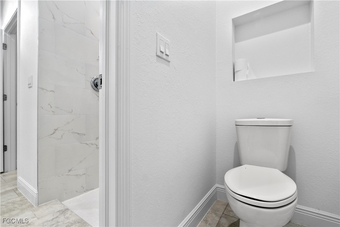 5008 Myrtlewood Road LaBelle, FL 33935 - Photo 19 of 37 a white toilet sitting next to a bathroom sink